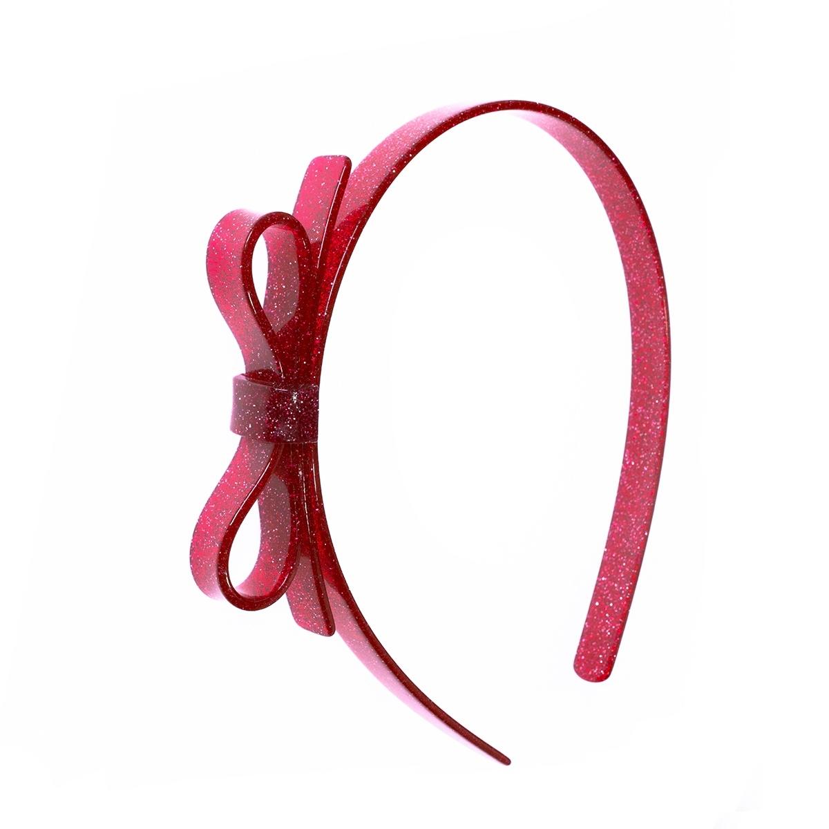 Red glittery headband with a bow on a white background