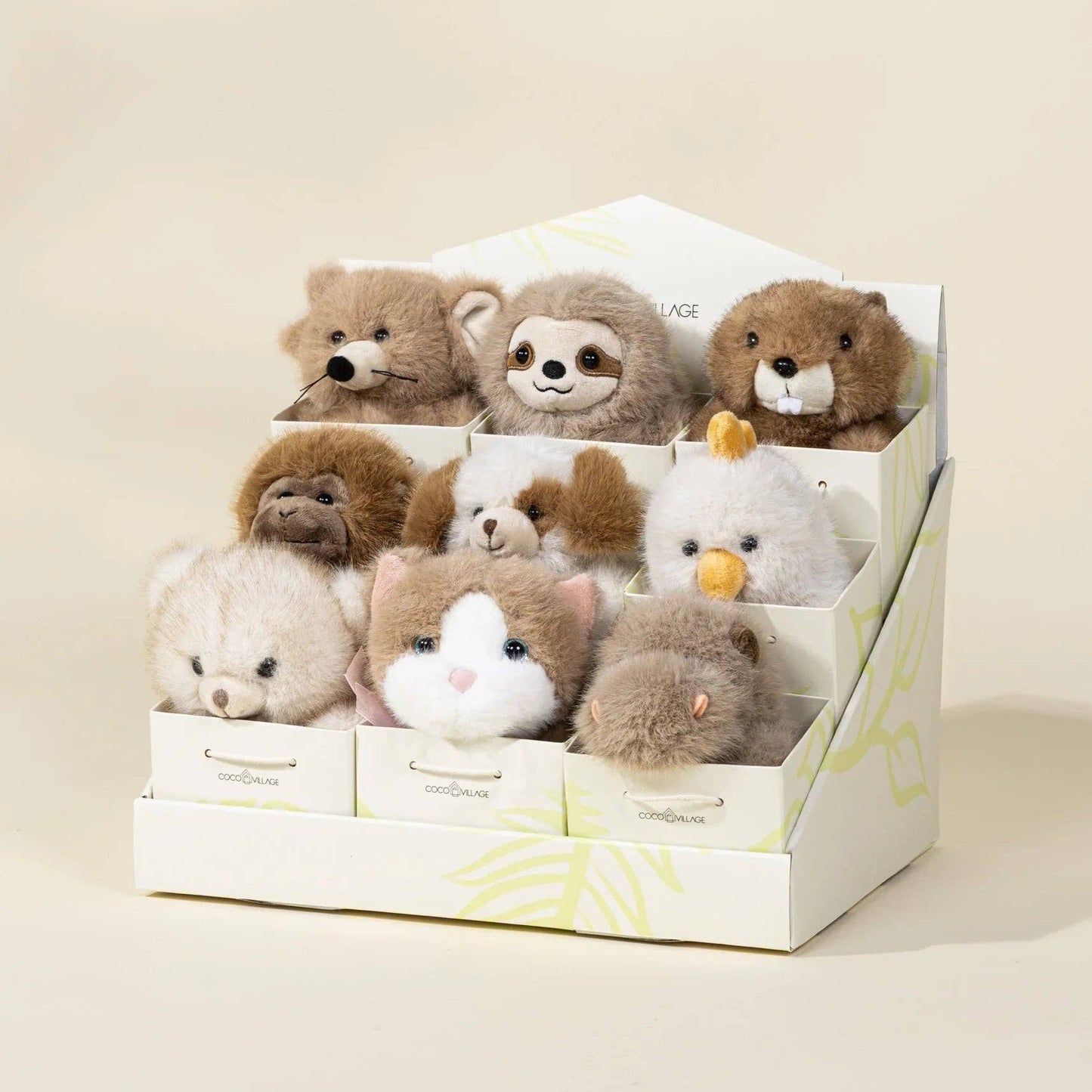 Set of small stuffed animals in a display box on a beige background