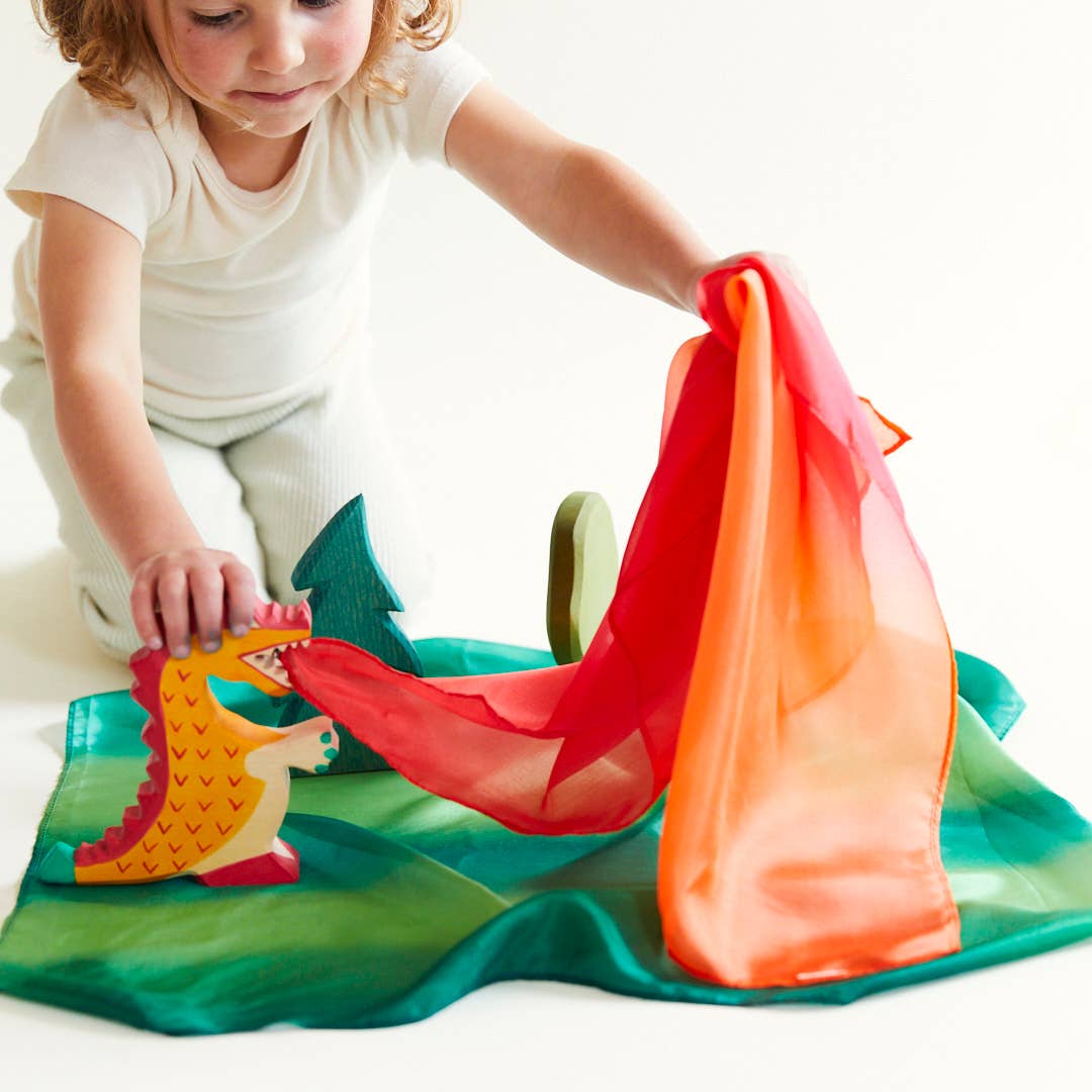 Child playing with a colorful toy on a white background
