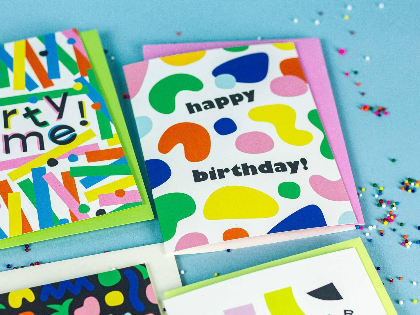 Colorful birthday cards with abstract designs on a blue background