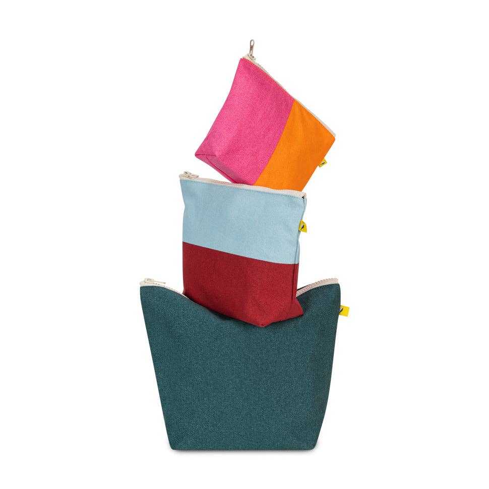 Stack of colorful fabric pouches on a white background