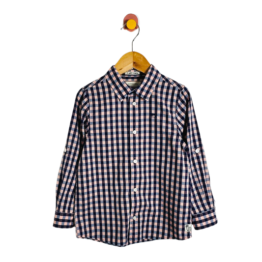 Checkered shirt on a hanger against a white background