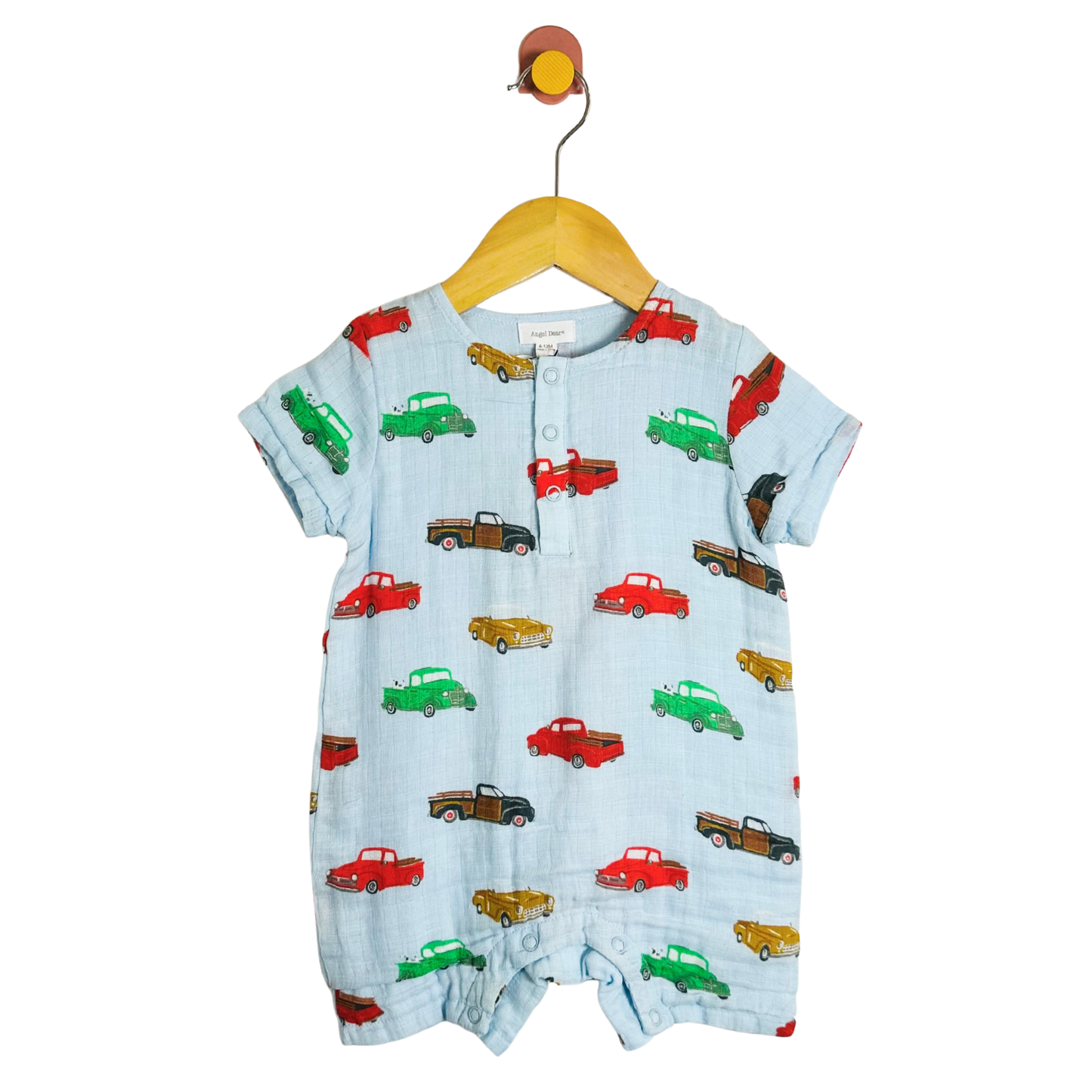 Baby romper with car pattern on a hanger against a white background