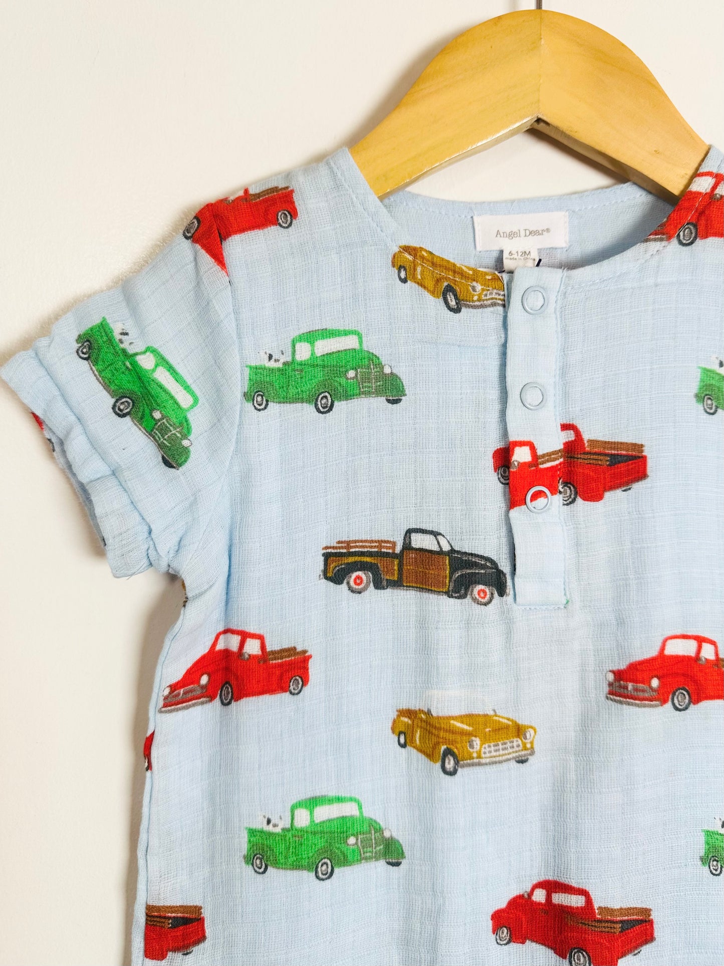 Children's shirt with vintage truck pattern on a hanger