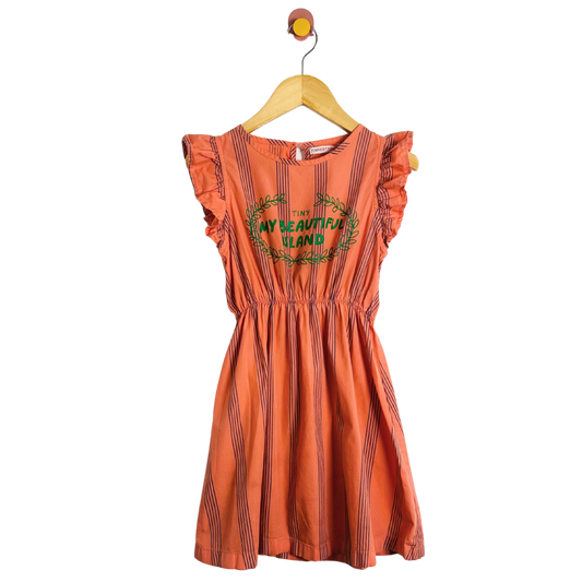 Orange dress with text and graphics on a hanger against a white background
