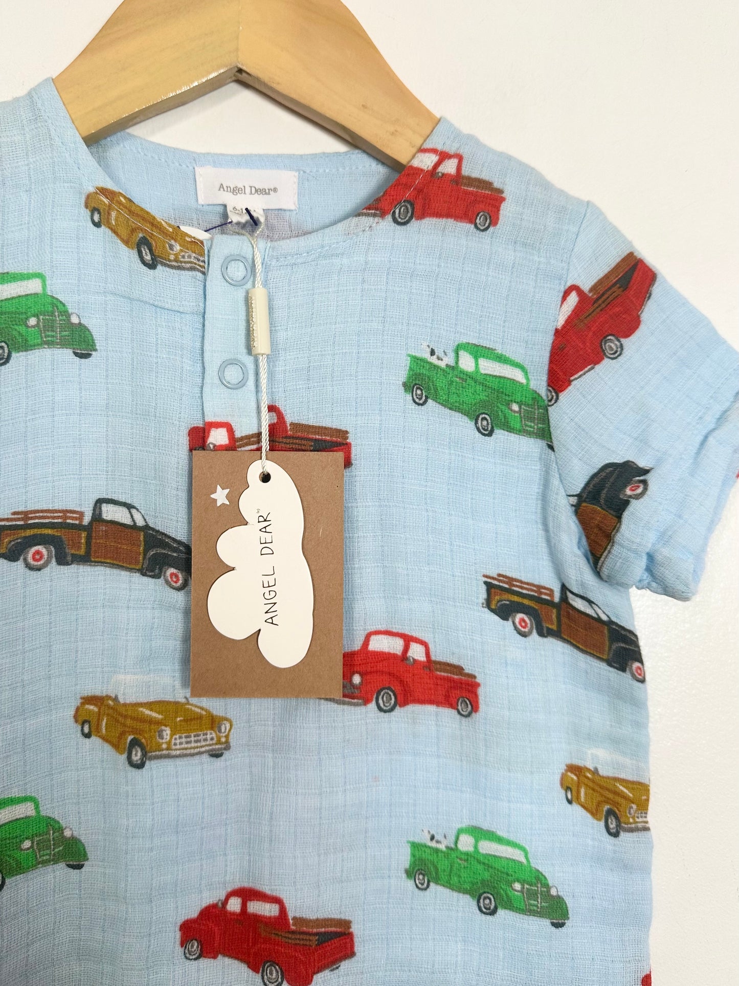 Children's shirt with truck pattern on a hanger