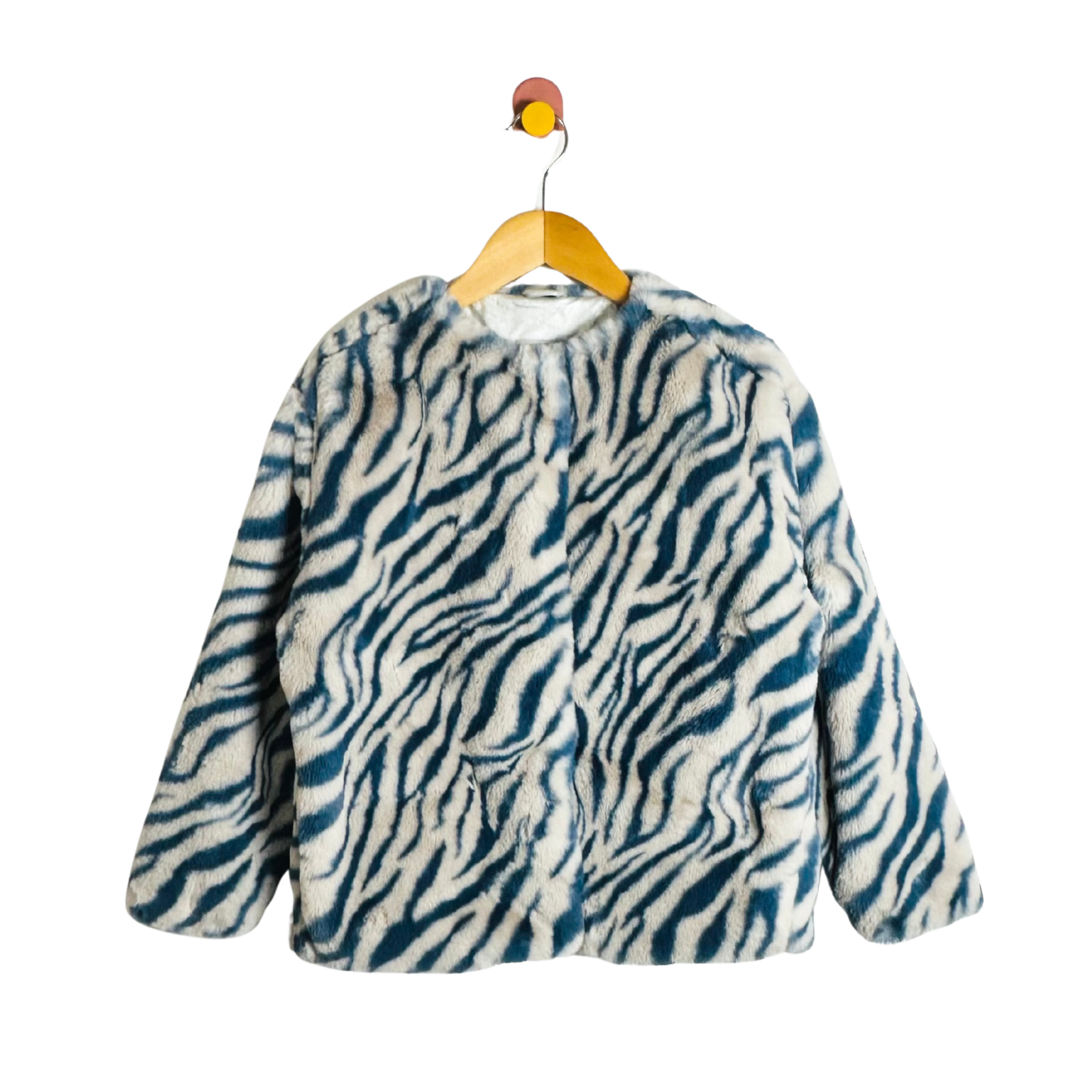 Zebra patterned coat on a hanger against a white background