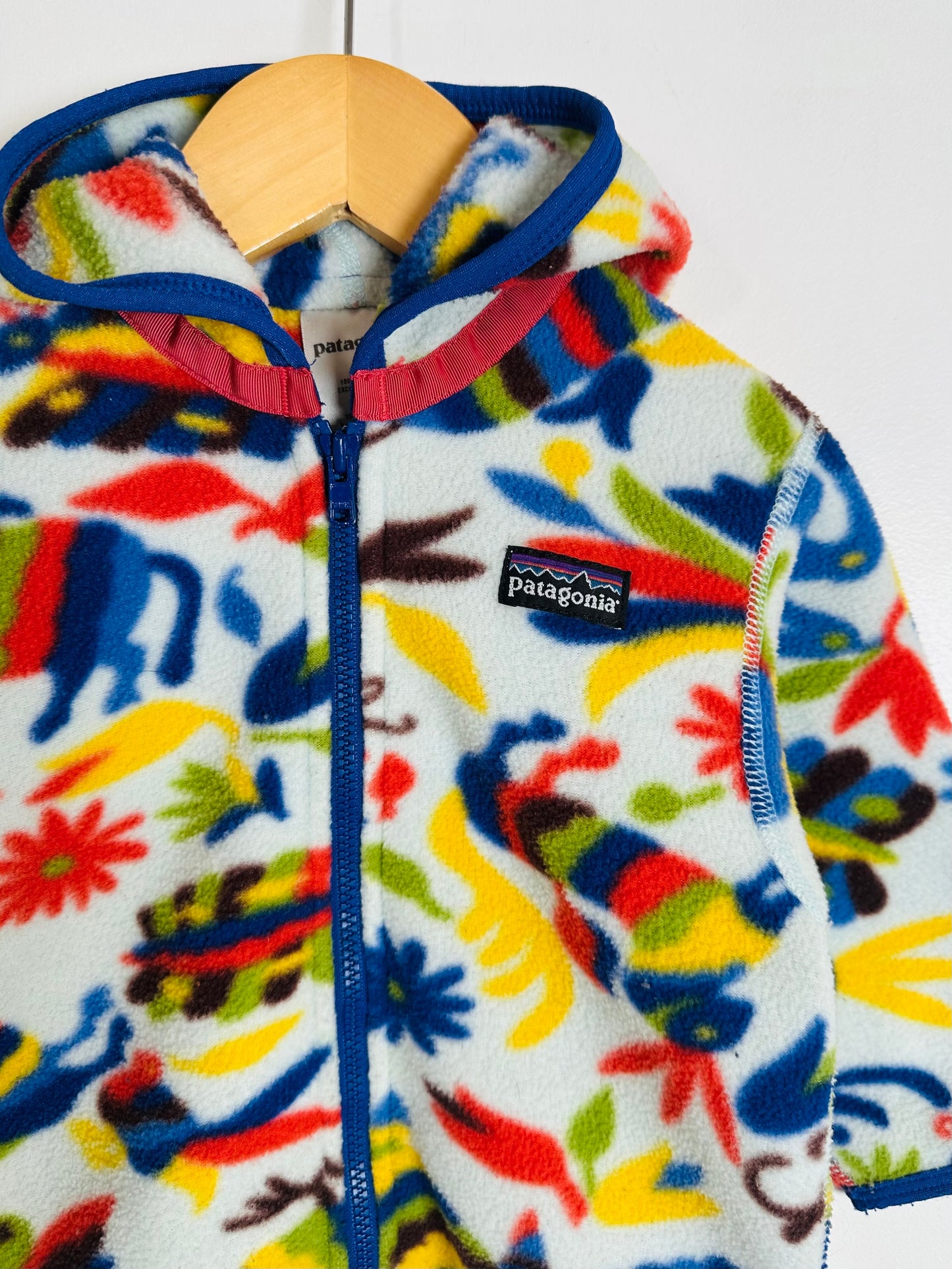 Colorful children's fleece jacket with a Patagonia logo on a white background