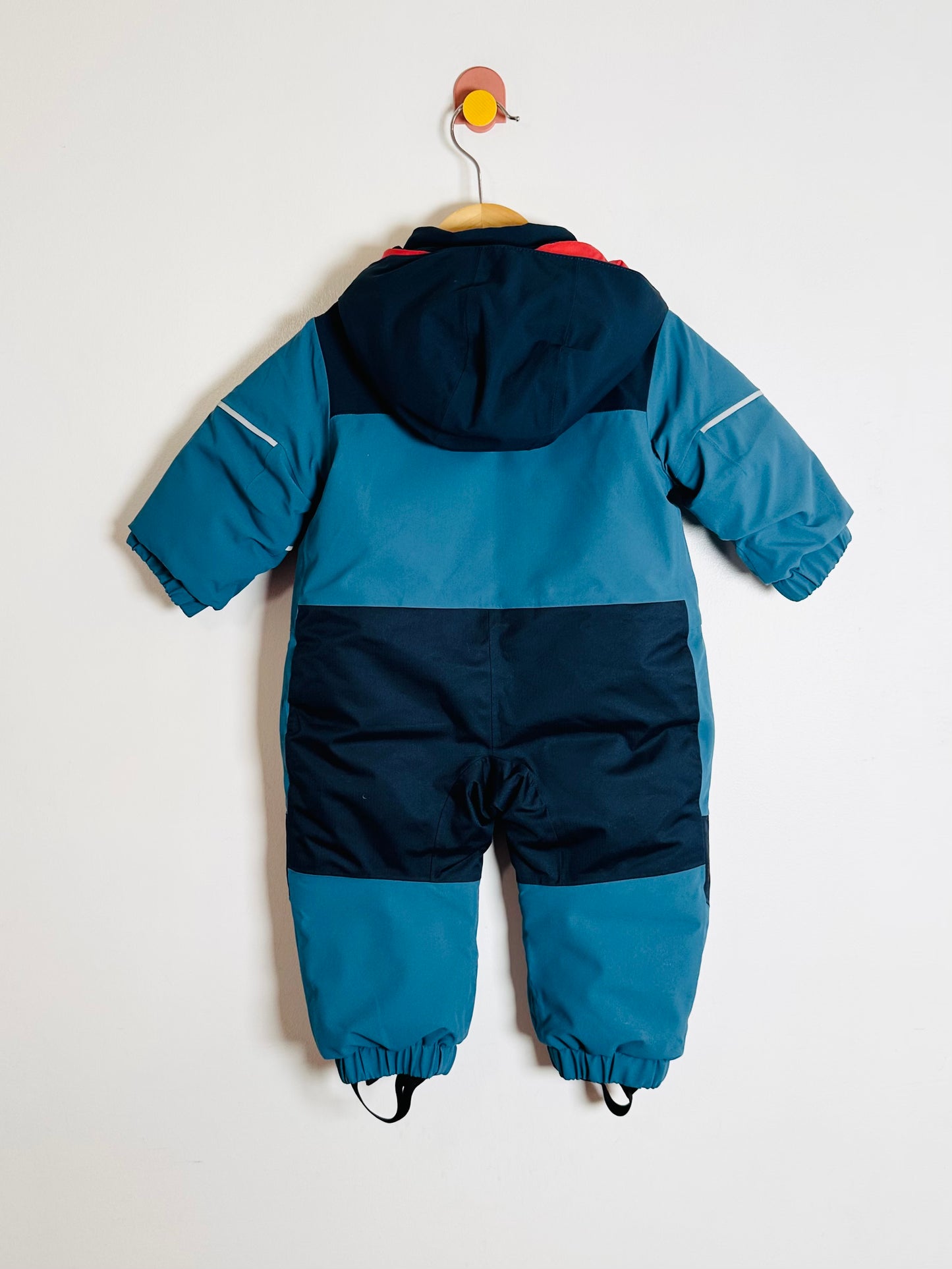 Blue and navy children's snowsuit on a white background