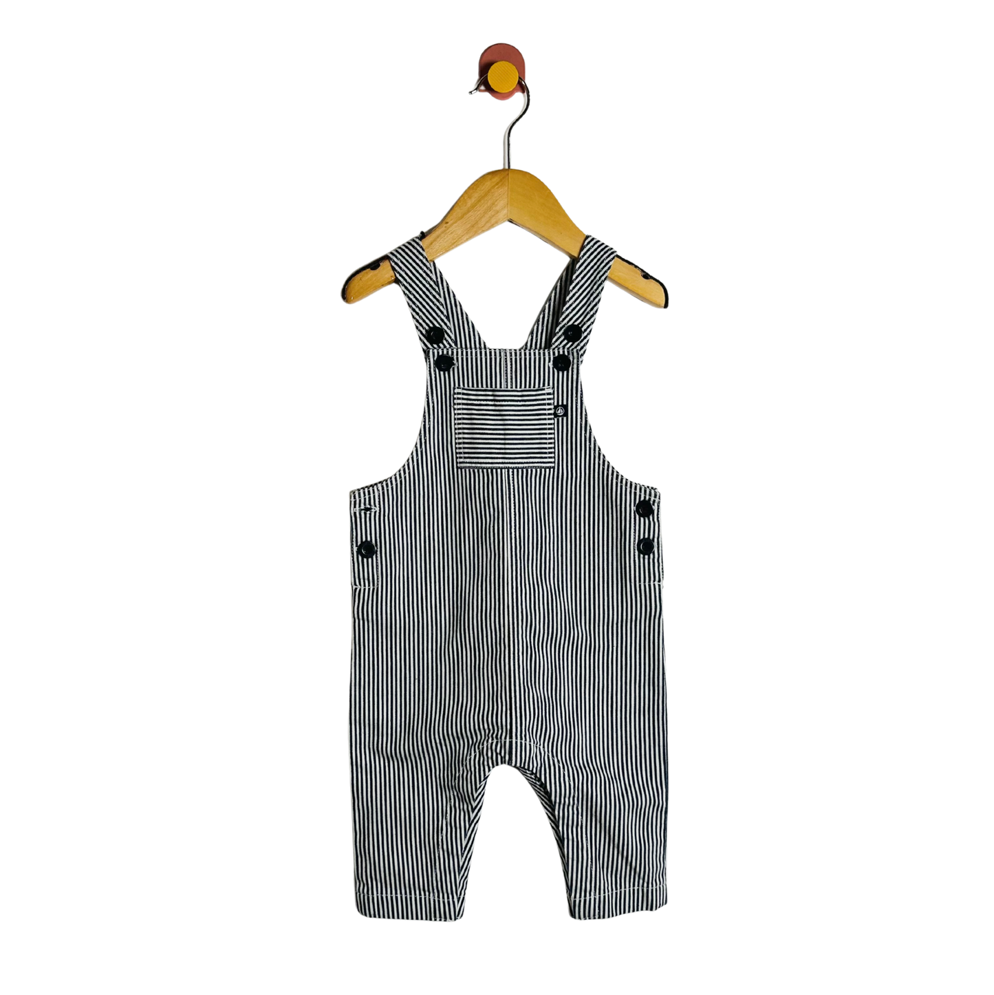 Black and white striped overalls on a hanger against a white background