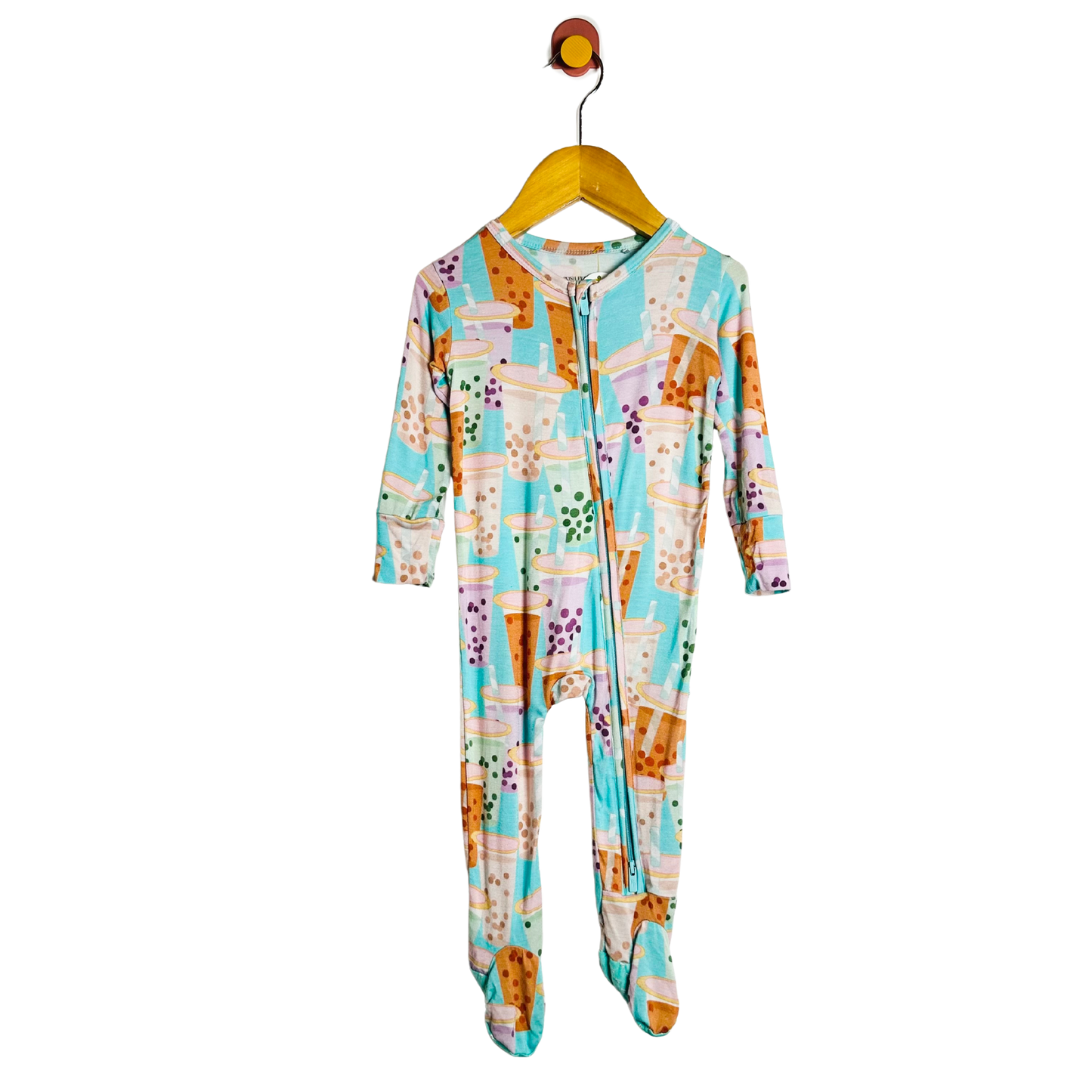 Colorful onesie with a pattern on a hanger against a white background