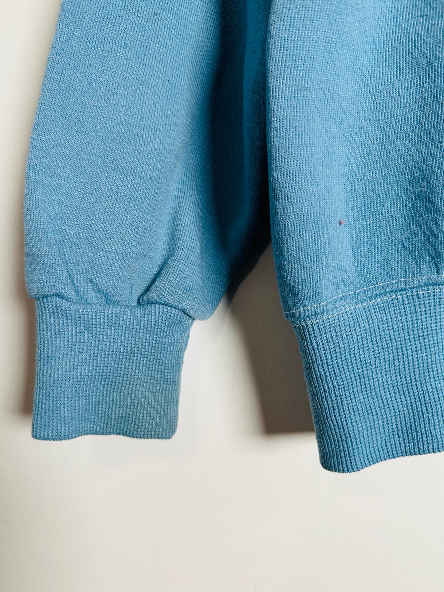 Close-up of a blue sweater on a light background