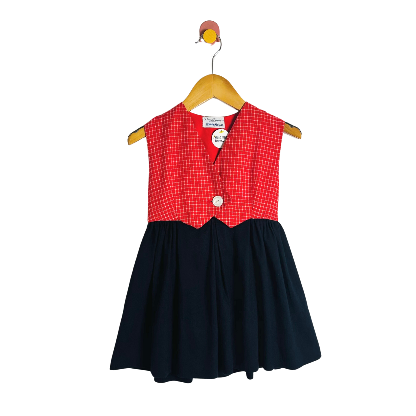Children's dress with red checkered top and navy skirt on a hanger against a white background