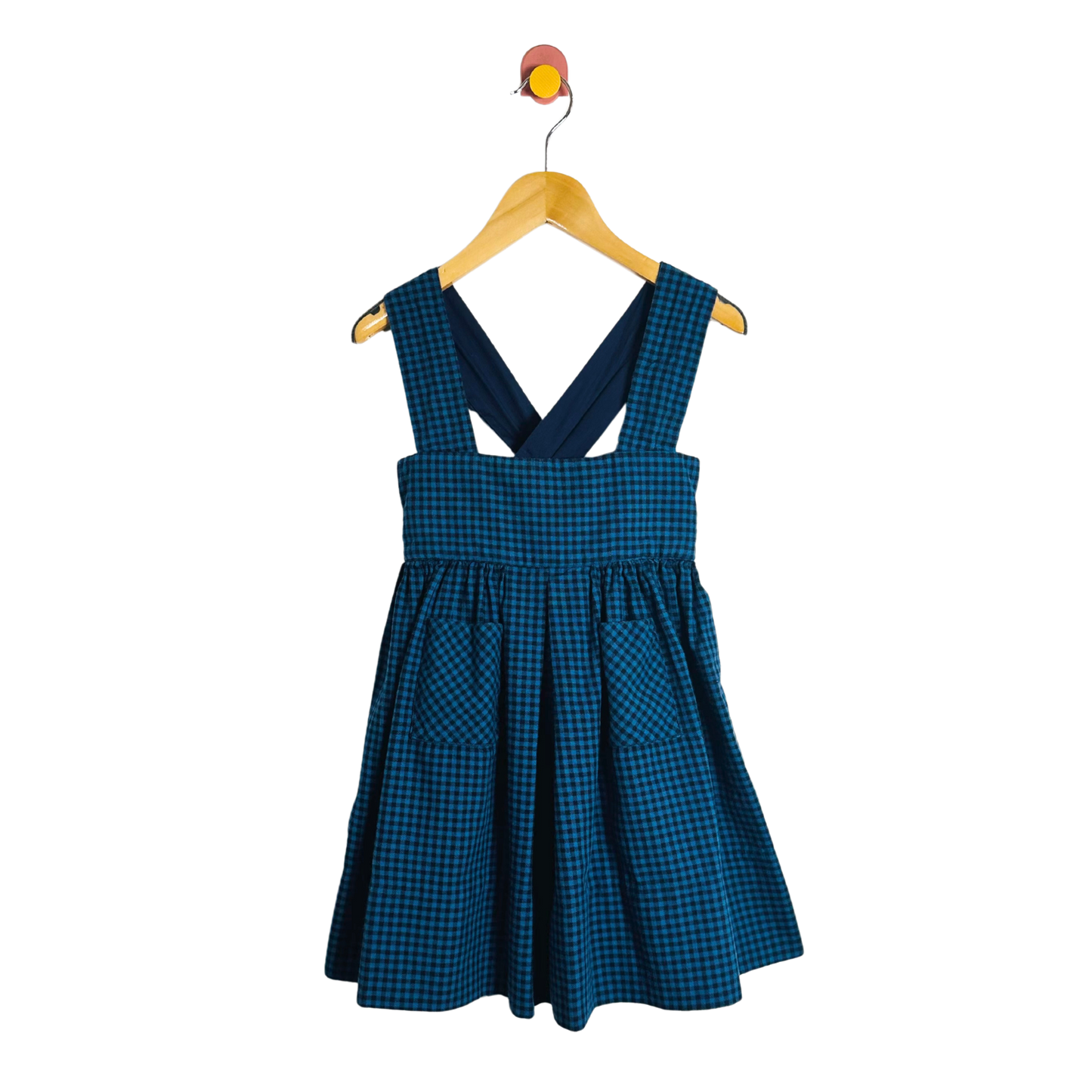 Blue checkered dress on a hanger against a white background