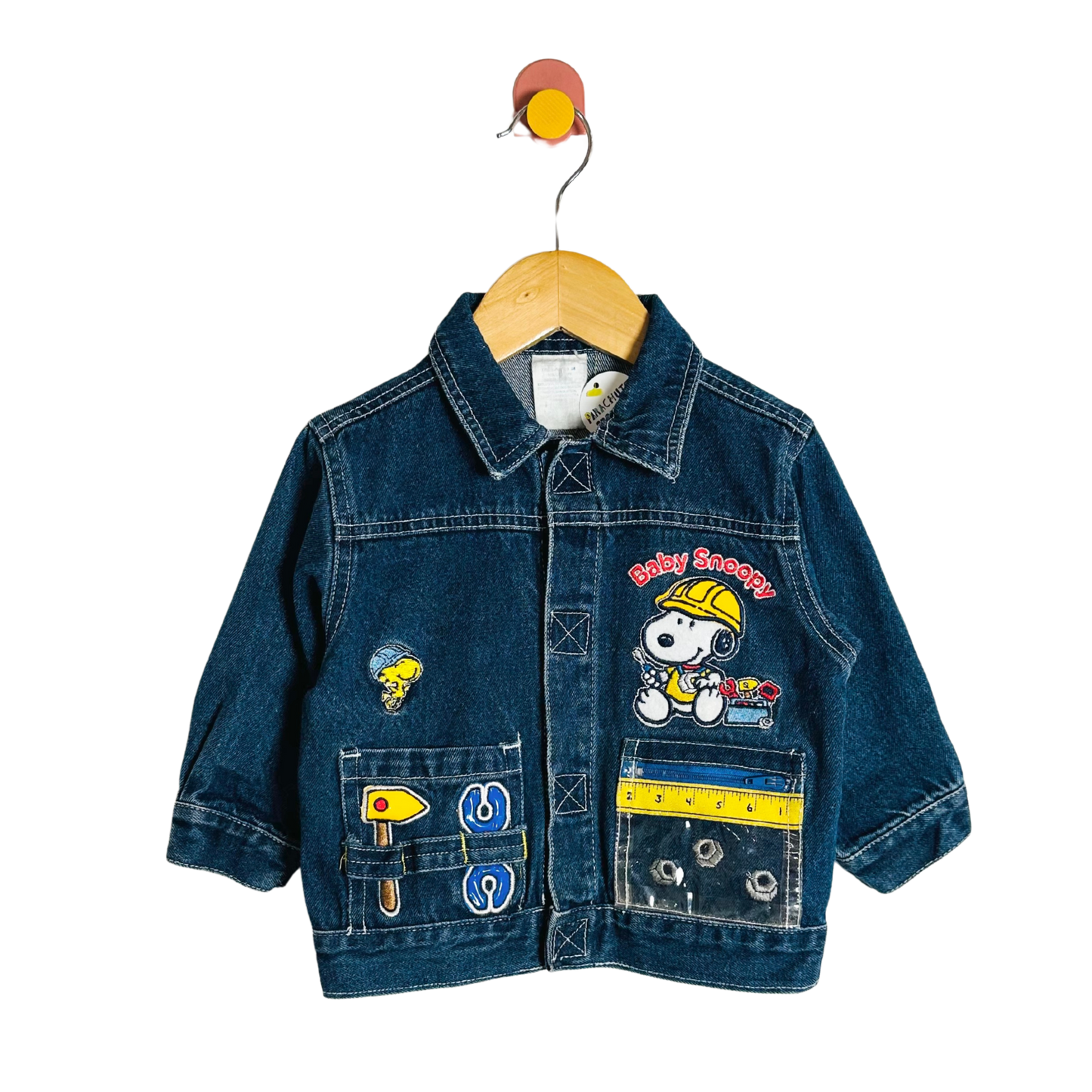 Children's denim jacket with cartoon character design on a hanger against a white background