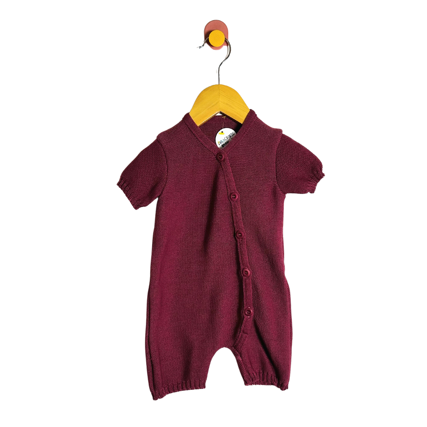 Maroon baby romper on a hanger against a white background