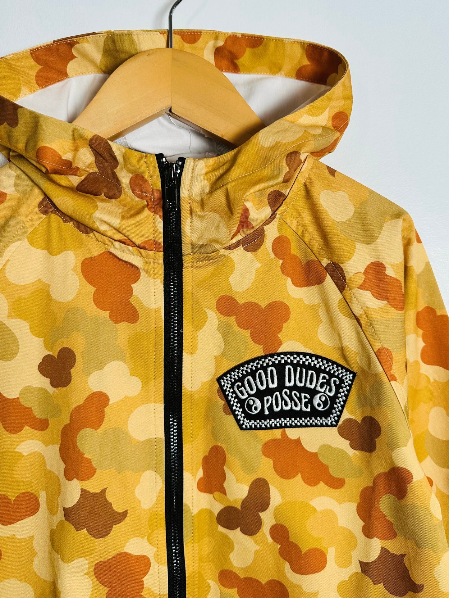 Camouflage-patterned jacket with a visible brand logo on a white background