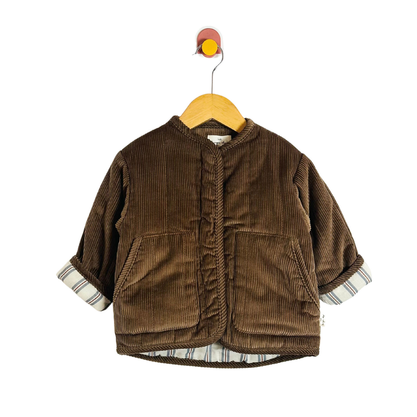 Brown corduroy jacket on a hanger against a white background