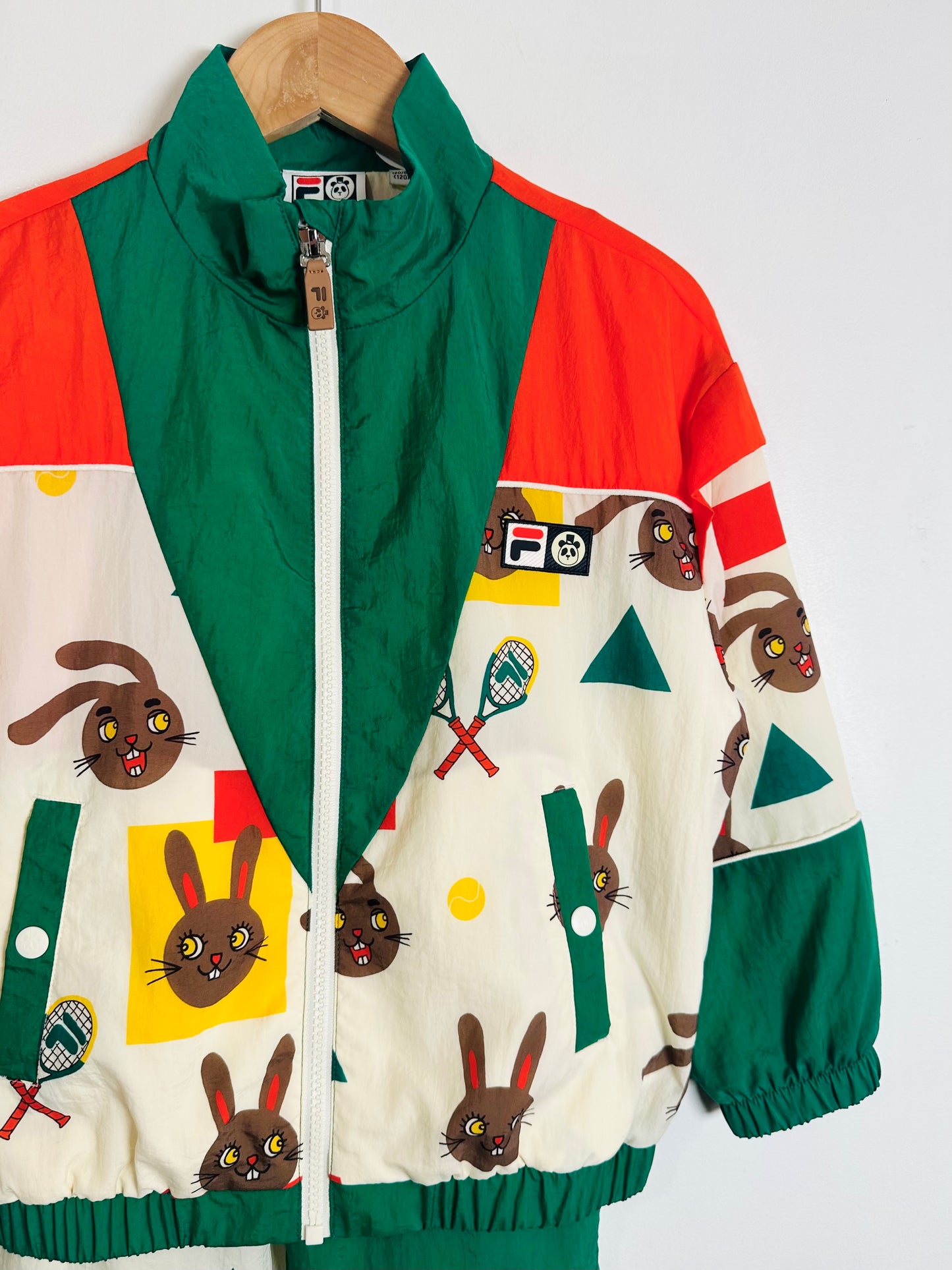 Colorful jacket with cartoon animal designs on a white background