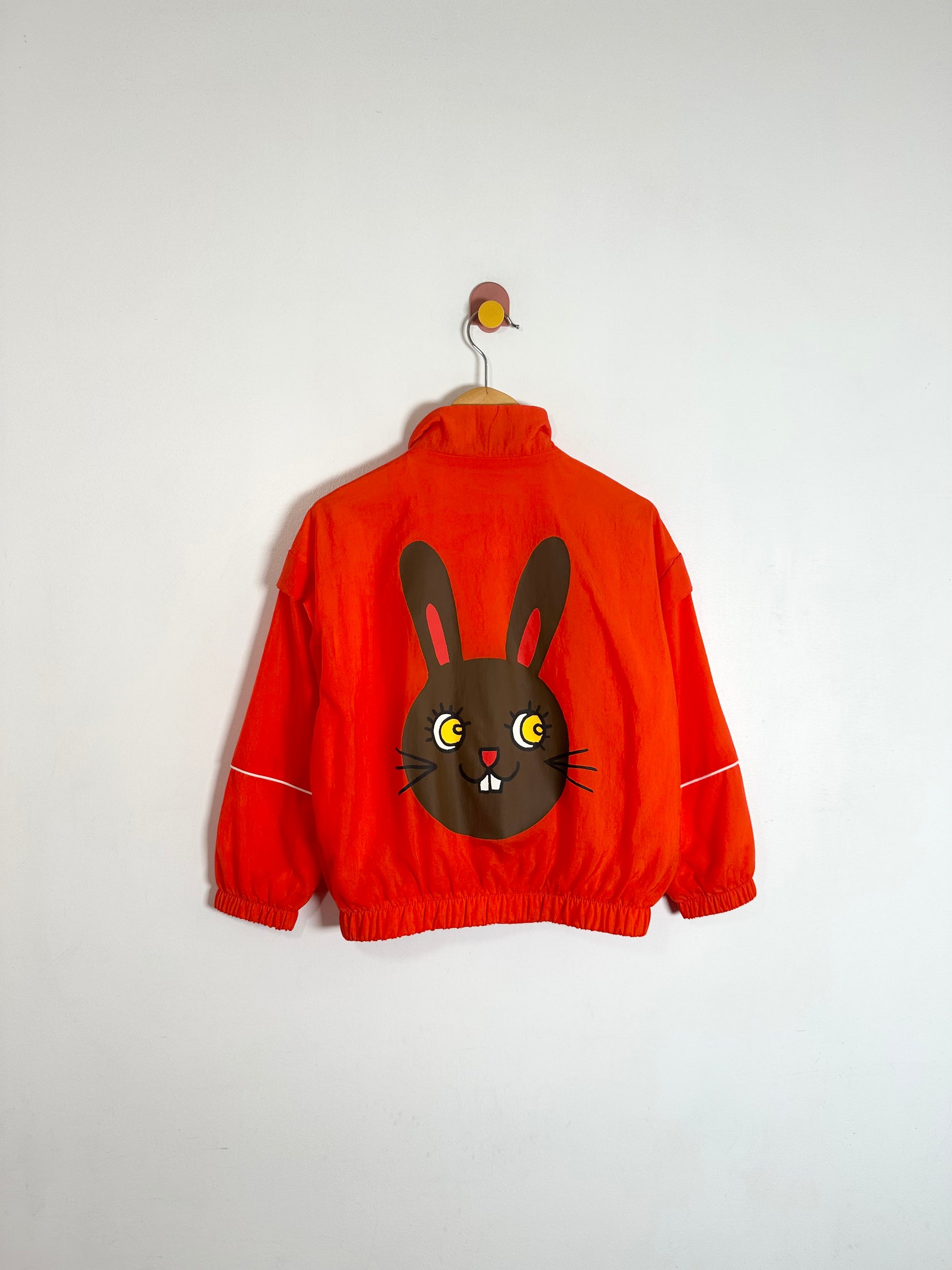 Red jacket with a cartoon bunny design on a white background