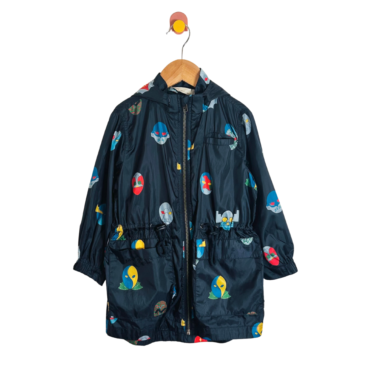 Children's dark blue raincoat with colorful cartoon designs on a white background