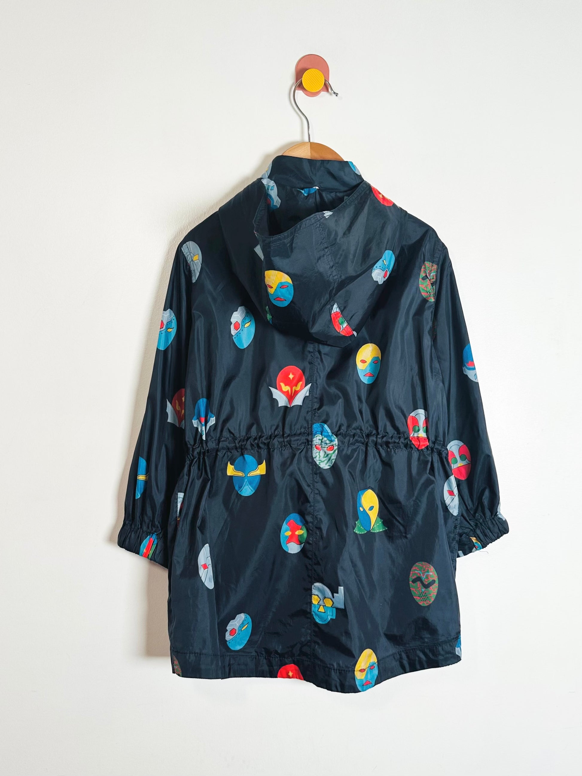 Children's navy raincoat with colorful patterns on a white background