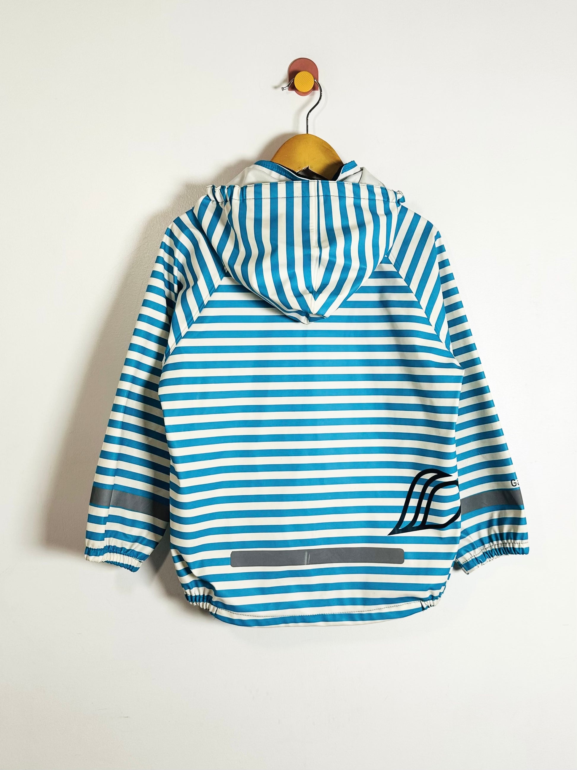Blue and white striped jacket on a wooden hanger against a light background