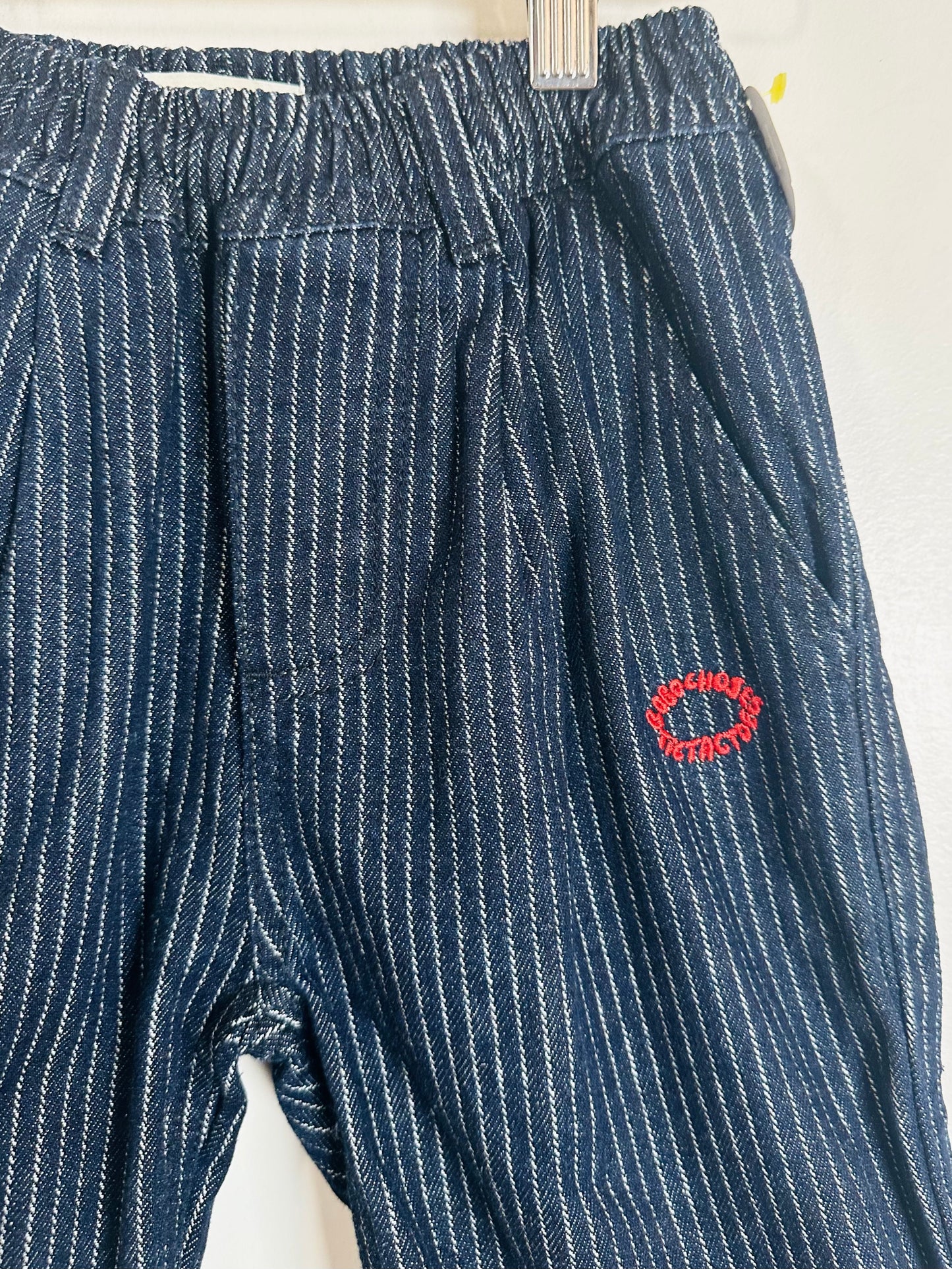 Blue pinstripe pants with a red logo on a white background