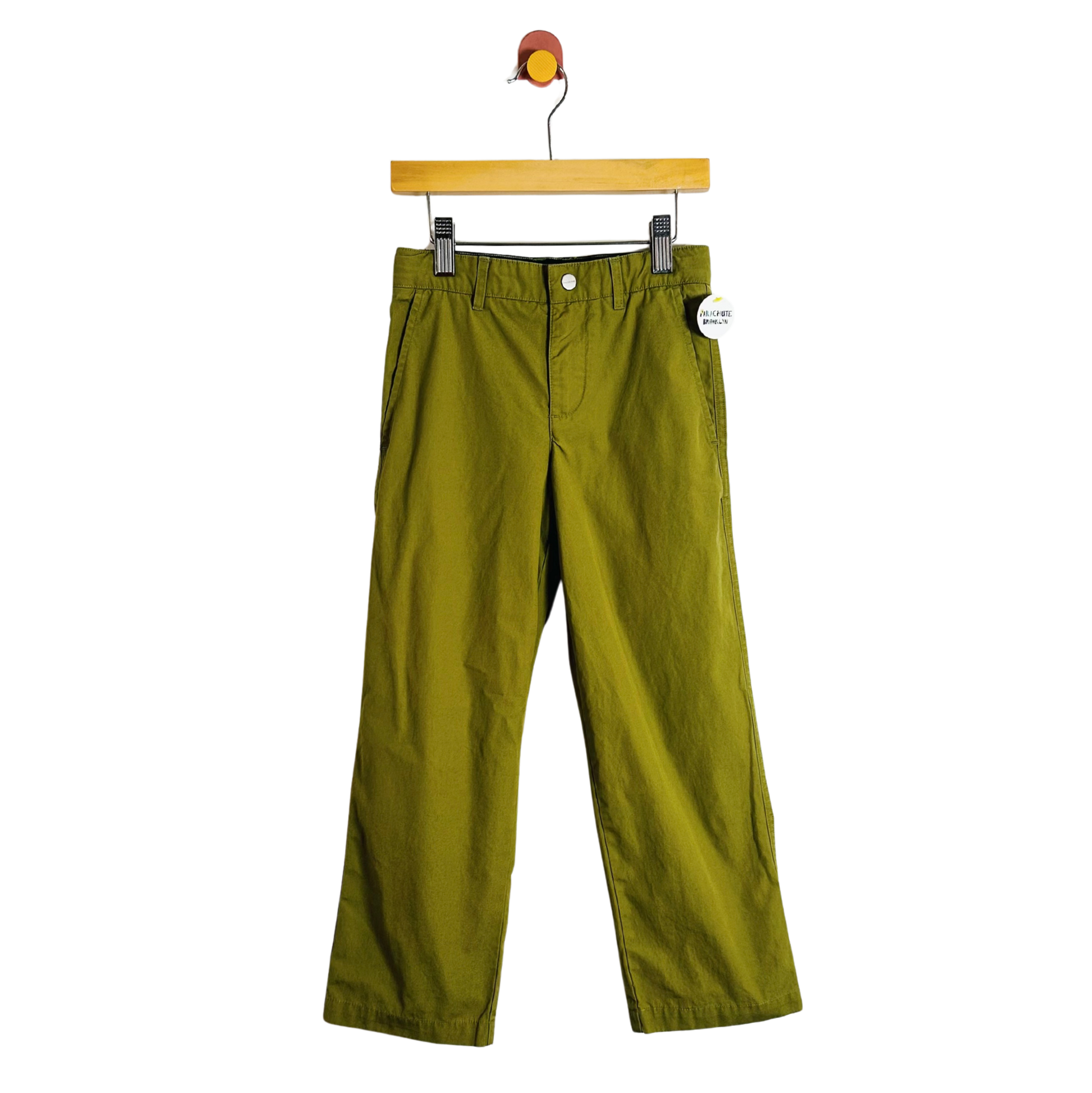 Green pants on a hanger with a white background