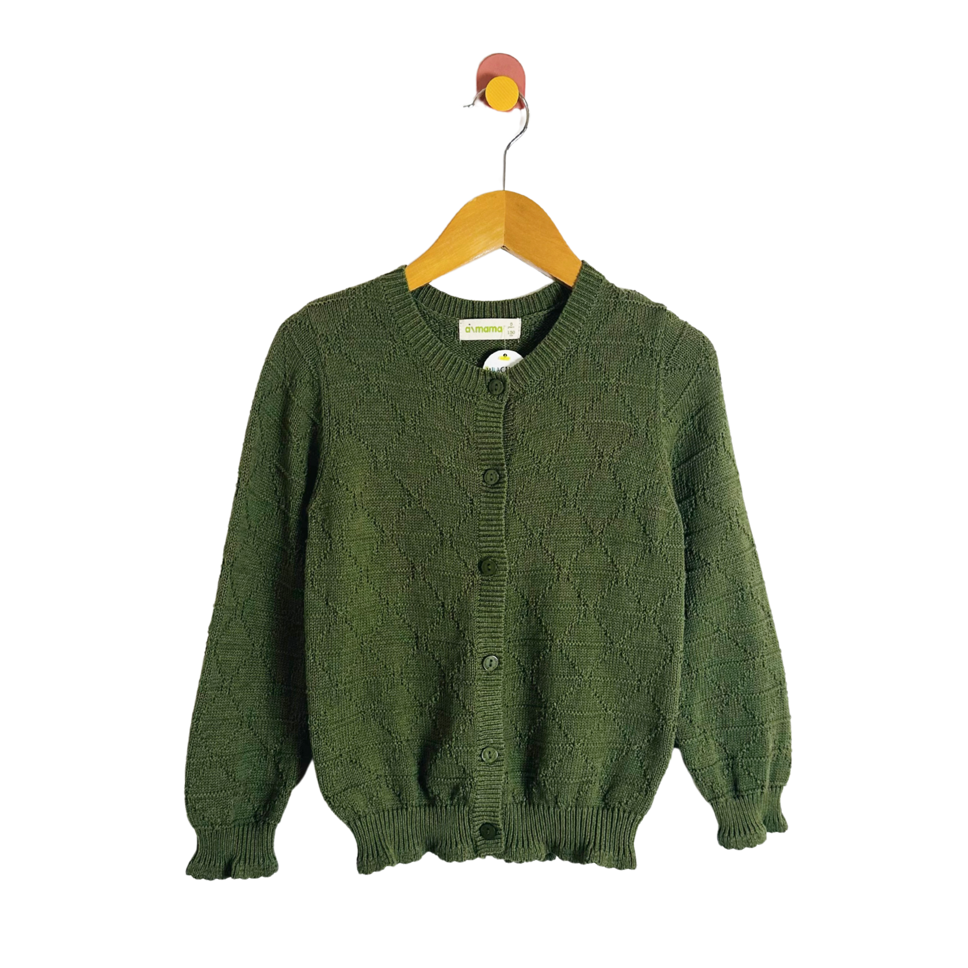 Green knitted cardigan on a wooden hanger against a white background