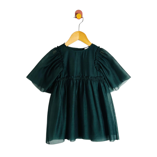 Green dress on a wooden hanger against a white background