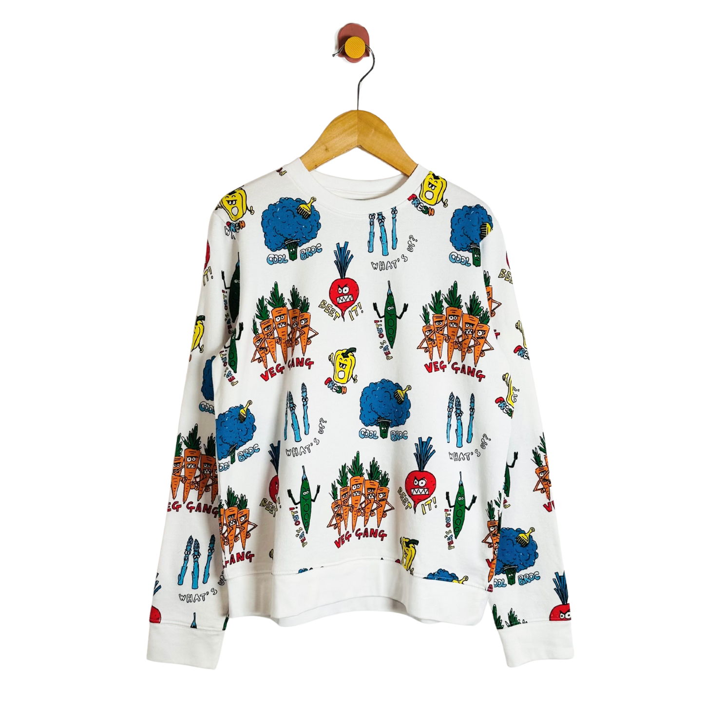White sweatshirt with colorful graphic designs on a hanger against a white background