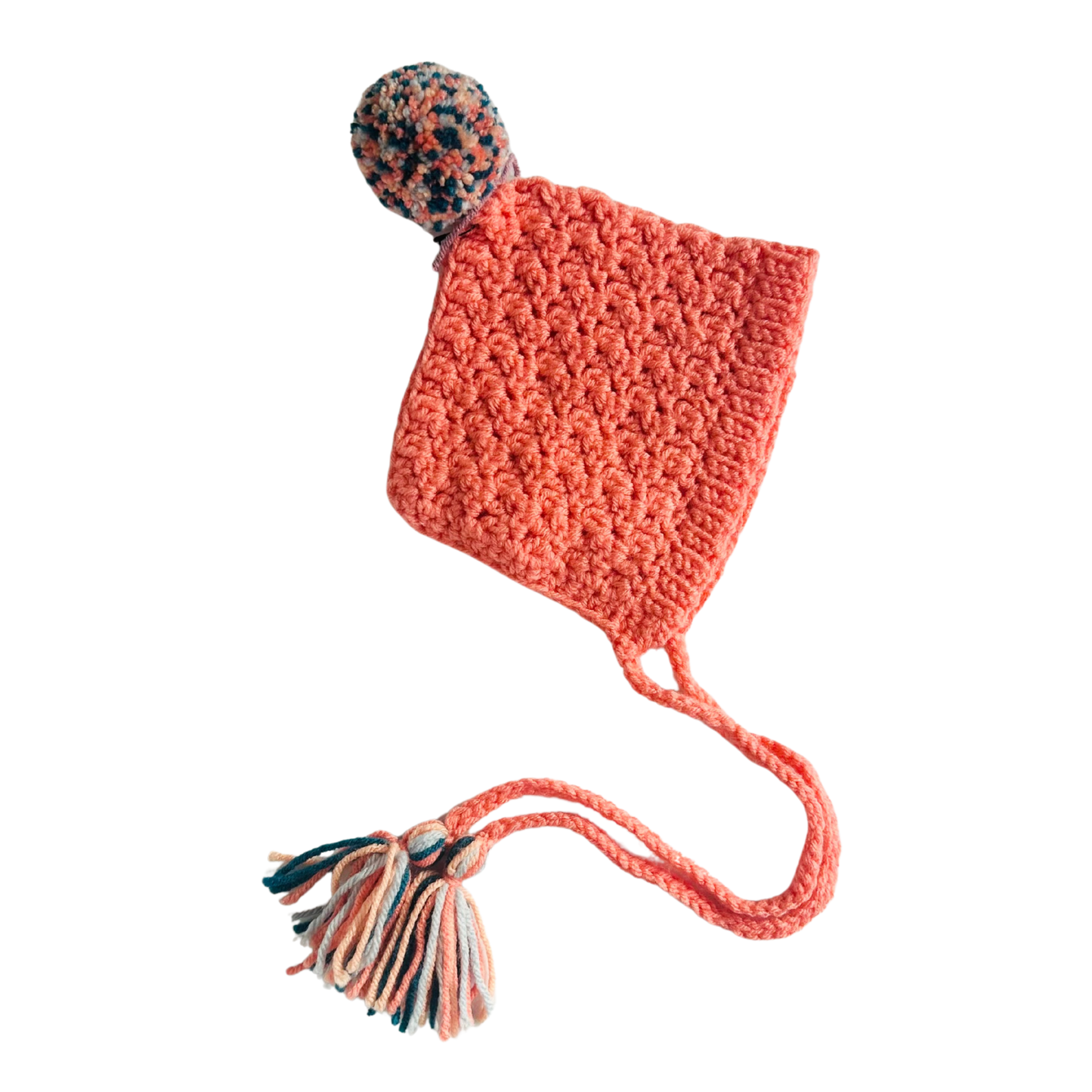 Crocheted pink hat with a pom-pom on a white background