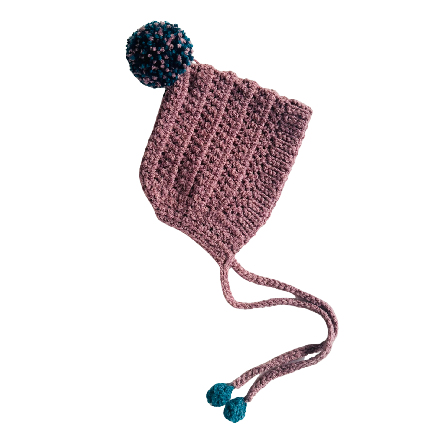 Pink knitted hat with blue pom-poms on a white background