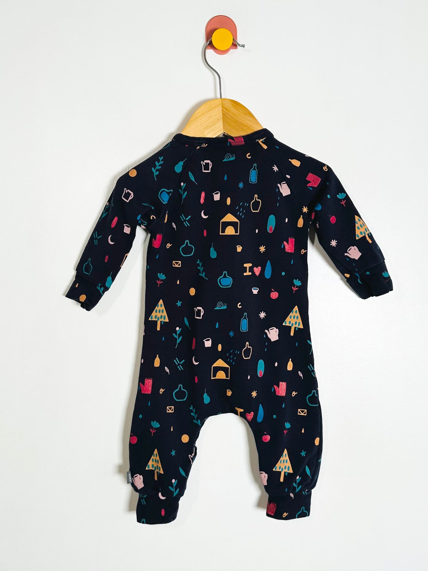 Baby onesie with colorful patterns on a white background