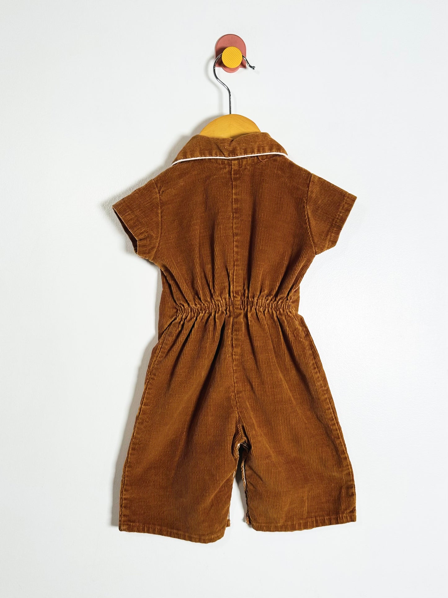 Brown children's jumpsuit on a white background