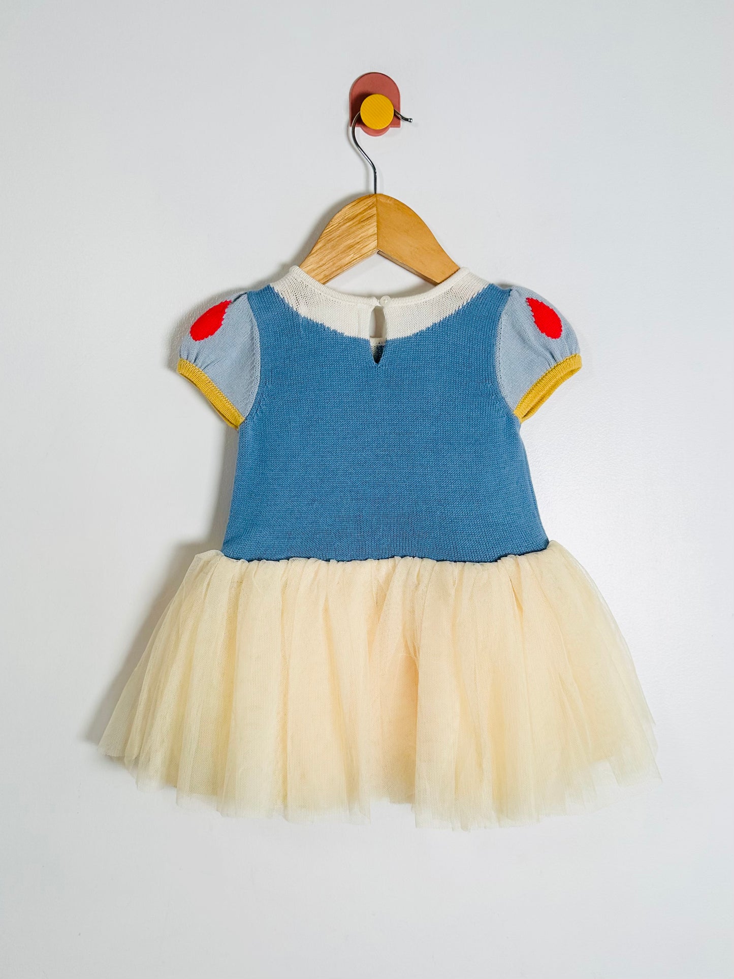 Children's dress with blue top and tulle skirt on a hanger against a white background