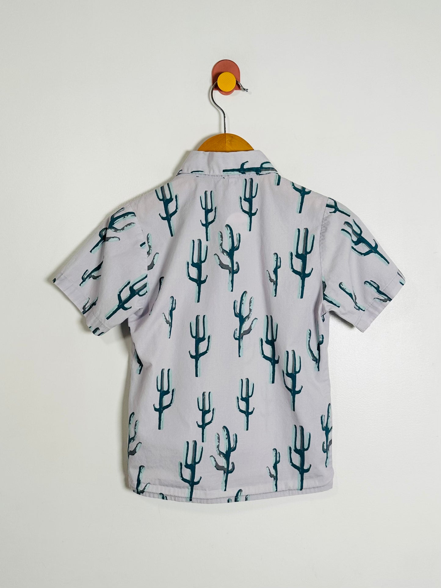Children's shirt with cactus pattern on a white background