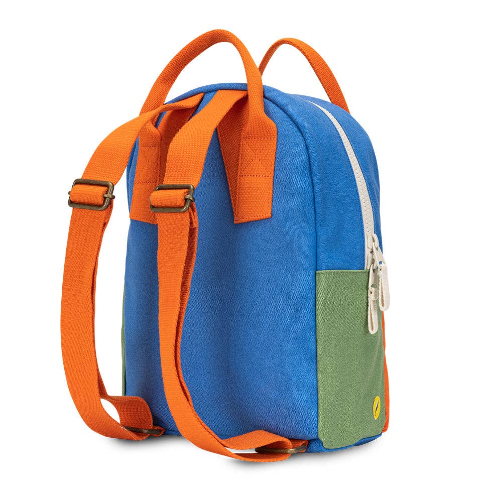 Blue and orange backpack with a green patch on a white background