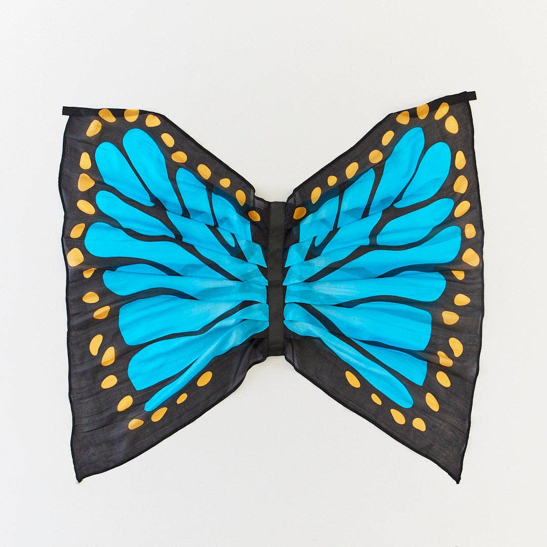 Butterfly wings with blue body and black and gold border on a white background