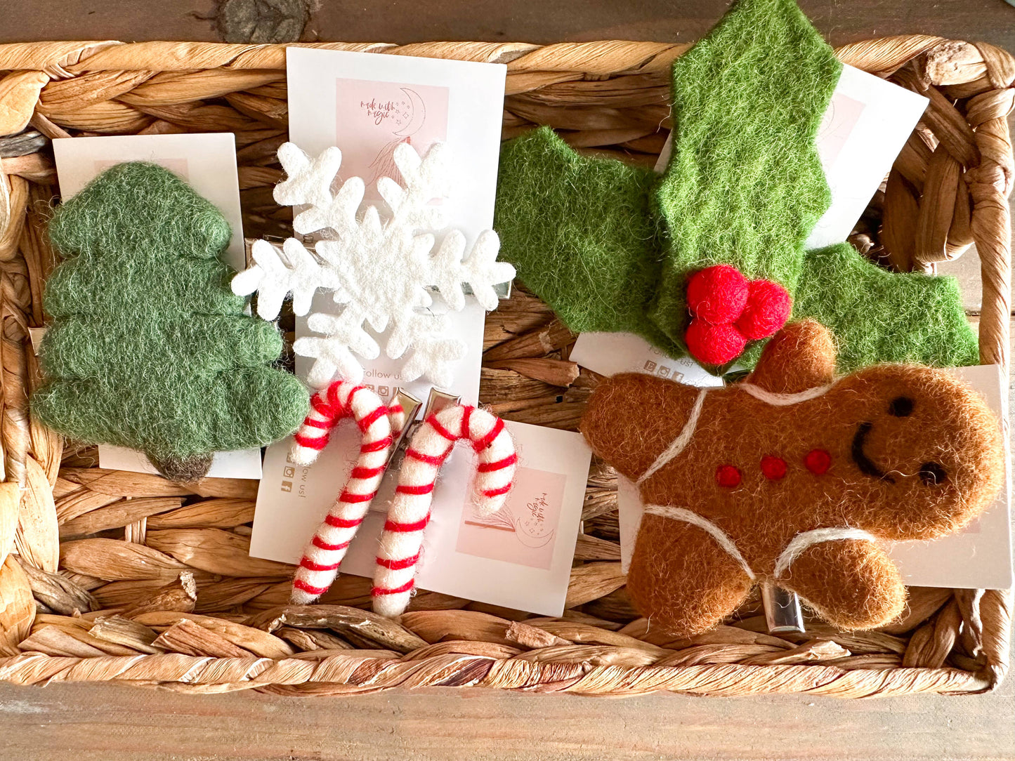 Decorative items including a gingerbread man, candy canes, snowflake, and holly leaves in a woven basket.