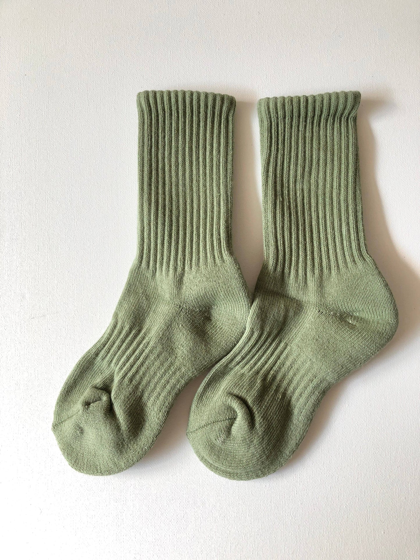 Pair of green socks on a white background
