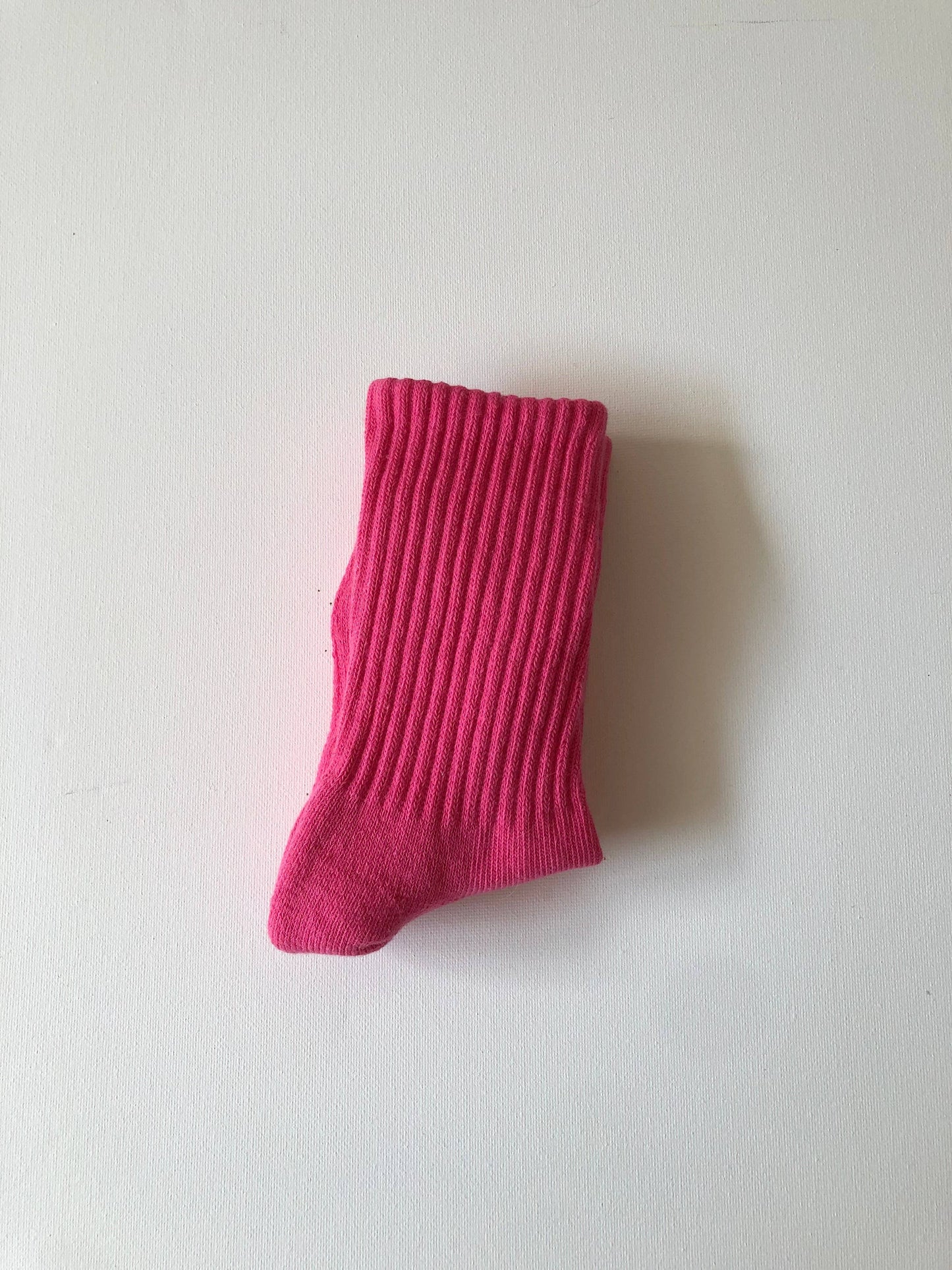 Single pink sock on a white background