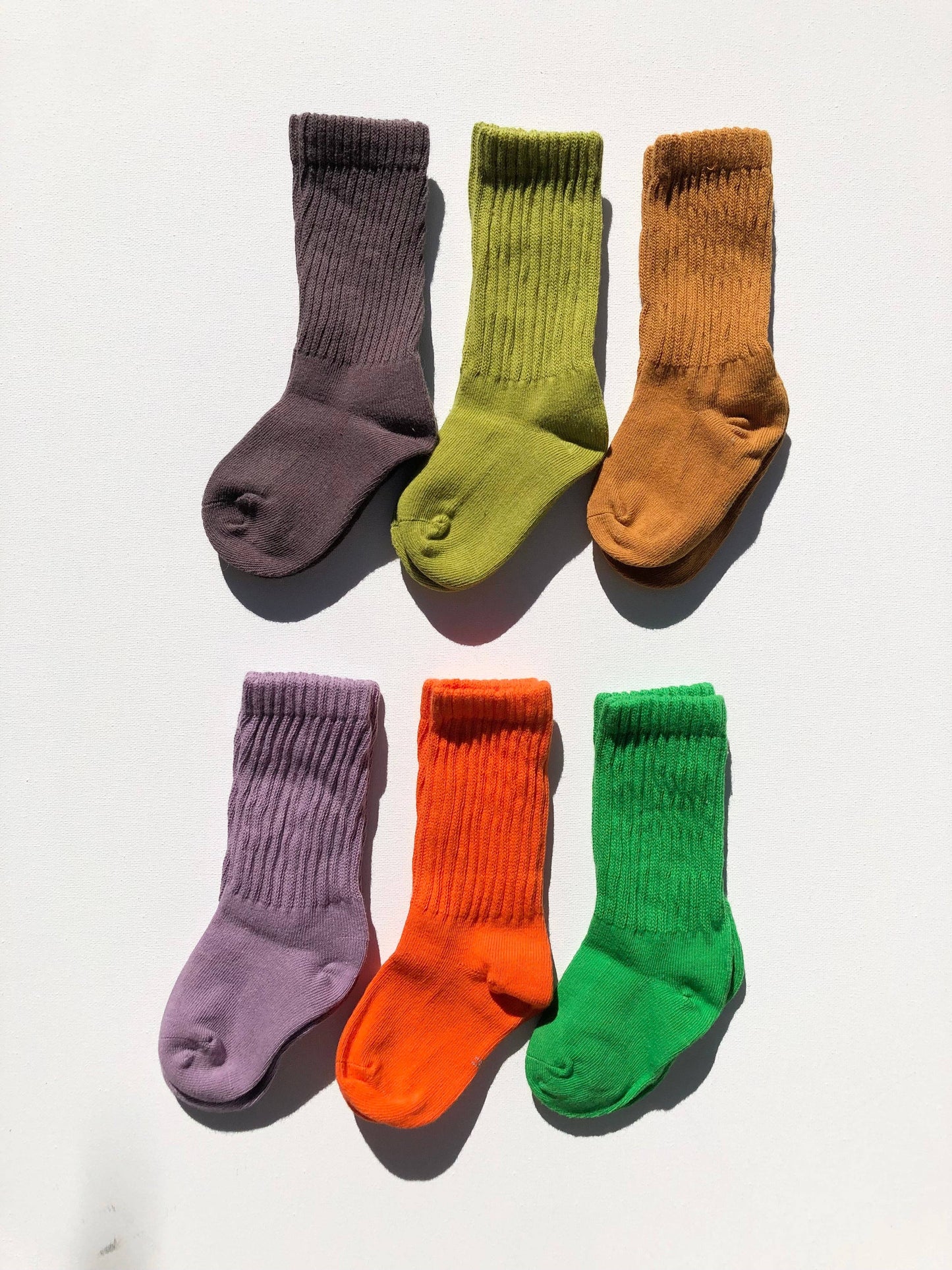 Set of six colorful socks arranged in two rows on a white background