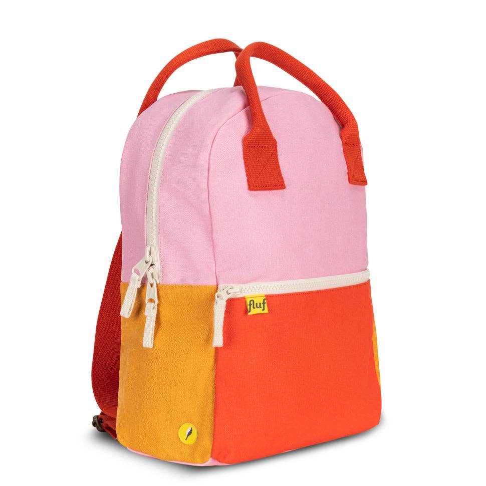 Color-blocked backpack with pink, orange, and red sections on a white background