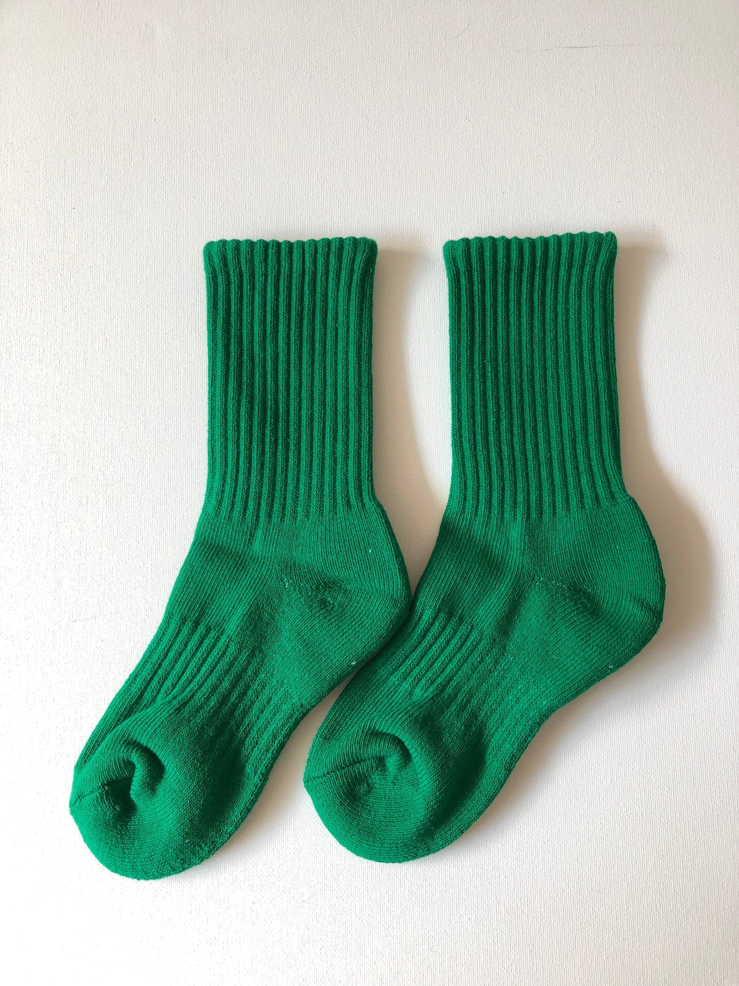 Pair of green socks on a white background