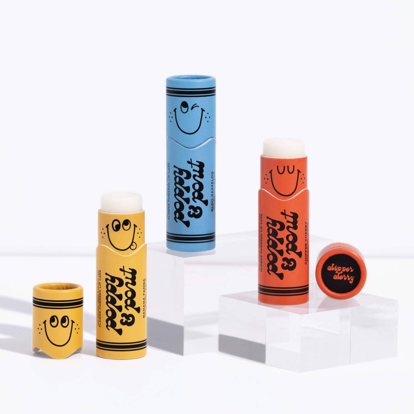 Set of colorful lip balm tubes with smiley face designs on a white background