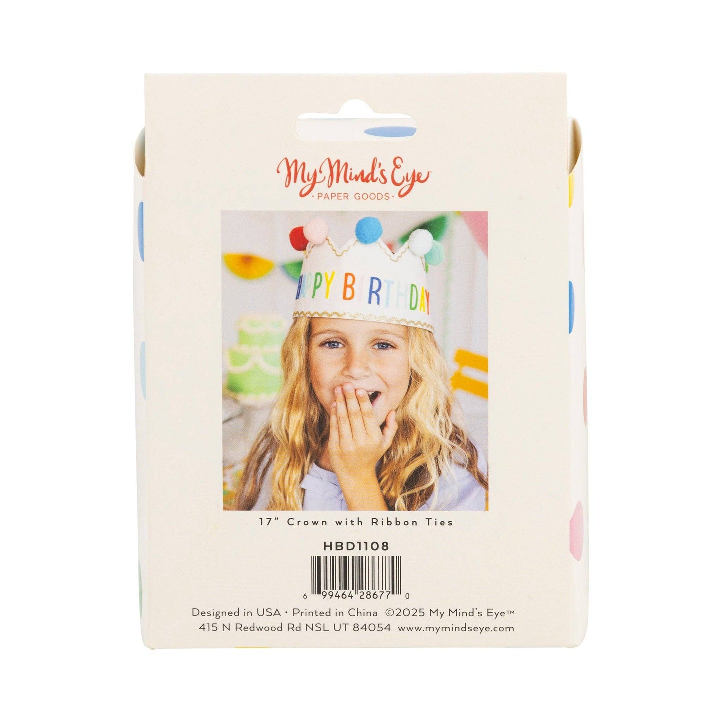 Packaging of a birthday crown with colorful ribbons and a photo of a child wearing it.
