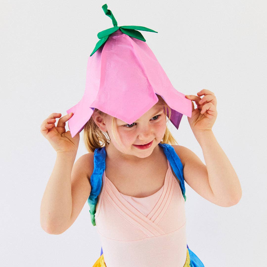 Child wearing a pink hat on a plain background
