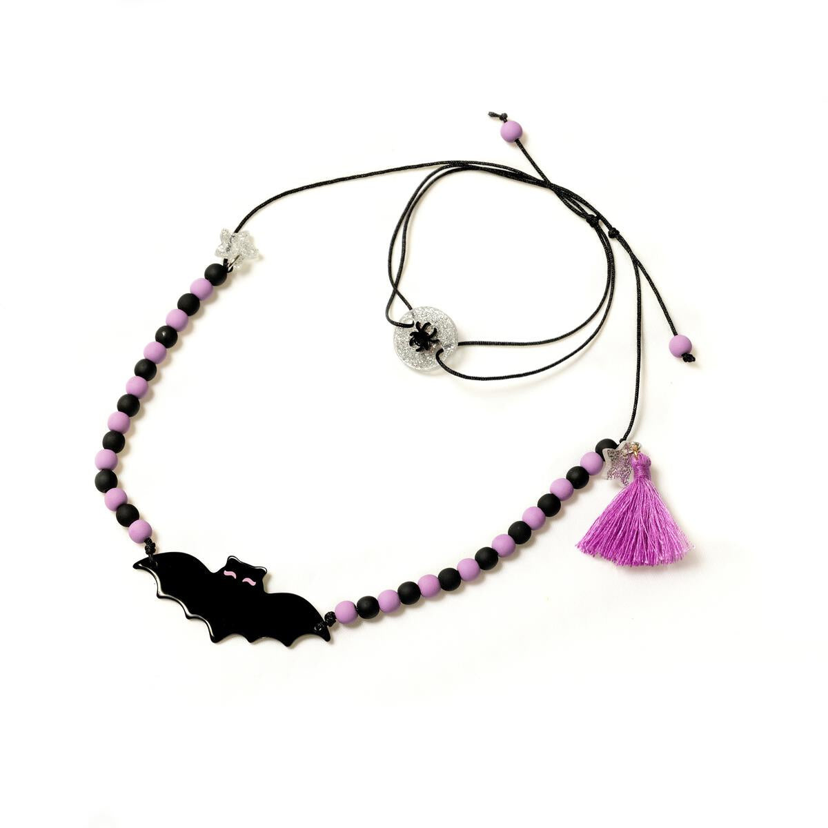 Necklace with bat charm and tassel on a white background